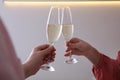 Women clinking glasses of champagne indoors  closeup. Holiday cheer and drink Royalty Free Stock Photo
