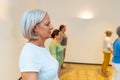 Women closing eyes breathing during a qigong class