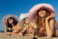Women with cocktail relaxing on beach