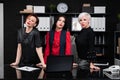 Three business women stand near Desk in office Royalty Free Stock Photo