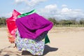 Three women with colorful capes dancing typical Wayuu dance. Indigenous culture of La Guajira, Colombia