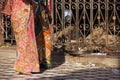 Women in colorful sari walking at Karni Mata Temple, Deshnok, In