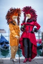 Women with colorful Venetian costume and mask