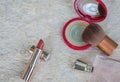 Women cosmetics and make-up tools with scented perfume on fur background