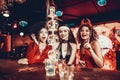 Women in Costumes Looking at Flaming Cocktail Royalty Free Stock Photo