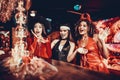 Women in Costumes Looking at Flaming Cocktail Royalty Free Stock Photo