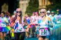 Women couple runs the Color Vibe 5K race. Royalty Free Stock Photo