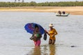 Women crosses a river, Morondava, Madagascar Royalty Free Stock Photo