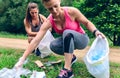 Women picking up trash doing plogging Royalty Free Stock Photo