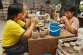 Women cut traditional tribal tattoo motives decoration at the raw kaolin in a workshop in Kuching, Malaysia.