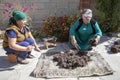 Women cutting and preparing wool for traditional felt making