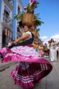 Women dancing in traditional Mexican dresses and carrying baskets on their heads