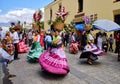 Women dancing in traditional Mexican dresses and carrying baskets on their heads