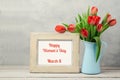 Women day concept, 8th of March with tulip flowers and photo frame