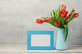 Women day concept, 8th of March with tulip flowers and photo frame