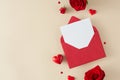 Top view composition made of red roses, hearts and open red envelope with white card Royalty Free Stock Photo
