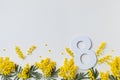 Women Day on 8 March celebration with fresh spring mimosa flowers and number eight top view. Beautiful holiday greeting card Royalty Free Stock Photo