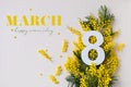 Women Day on 8 March celebration with fresh spring mimosa flowers and number eight top view. Beautiful holiday greeting Royalty Free Stock Photo