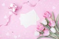 Women Day, Mother day background with envelope, gift box and beautiful spring tulip flowers on pastel pink desk. Flat lay