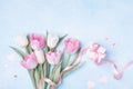 Women Day, Mother day background with gift box and beautiful spring tulip flowers on pastel blue table. Flat lay