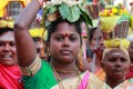 Women devotees carry scared pots in their heads and participates in the Thaipusam festival