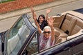 Women of different generations happy in a convertible car