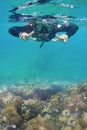 Women dives in a tropical sea