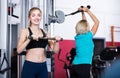 Women doing powerlifting on machines Royalty Free Stock Photo