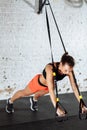 Women doing push ups training arms with trx straps in gym Royalty Free Stock Photo