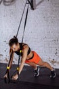 Women doing push ups training arms with trx straps in gym Royalty Free Stock Photo