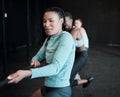 Women doing it for themselves. a group of young women pulling a rope in a game of tug of war at the gym.