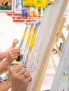 Women drawing on canvases during masterclass in the art studio, hands only