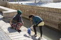 Women drawing water to clean from canal, Bukhara, Uzbekistan