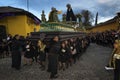 Women dressed in black carrying a giant float in a street of the old city of Antigua during a procession of the Holy Week