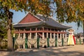 Women dressed in hanbok traditional dresses by the lake at Gyeongbokgung Palace