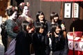 Women dressed up as geishas posing with a group of Japanese schoolgirls in Kyoto, Japan