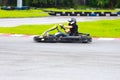 Women drive karting car on outdoor track