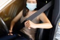Woman driver fastens seat belt before driving a car,Safety concept for vehicles