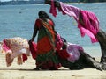 Women drying clothes on a beach