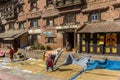 Women drying rice in front of the former palace in Kirtipur