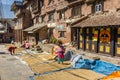 Women drying rice in front of the former palace in Kirtipur Royalty Free Stock Photo