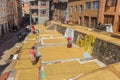 Women drying rice in front of their homes in Kirtipur