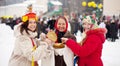 Women eating pancakes during Maslenitsa