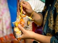 Women are eating roasted squid with seafood sauce in clear plastic bag along with ice cream