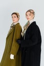women in elegant kerchiefs and coats