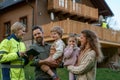 Woman engineer talking to young family about solar panel installation in front of their house.