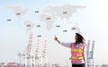 The women engineer working with container Cargo freight ship in shipyard at dusk for Logistic Import Export background, map earth Royalty Free Stock Photo