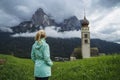 Women enjoy view of St Valentine's Church, Seis am Schlern, Italy. Schlern mountain with rainy clouds in background Royalty Free Stock Photo