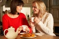 Women Enjoying Tea And Cake Together