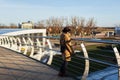 Women enjoys the view from Mitavas bridge over the river Driksa in Jelgava, Latvia